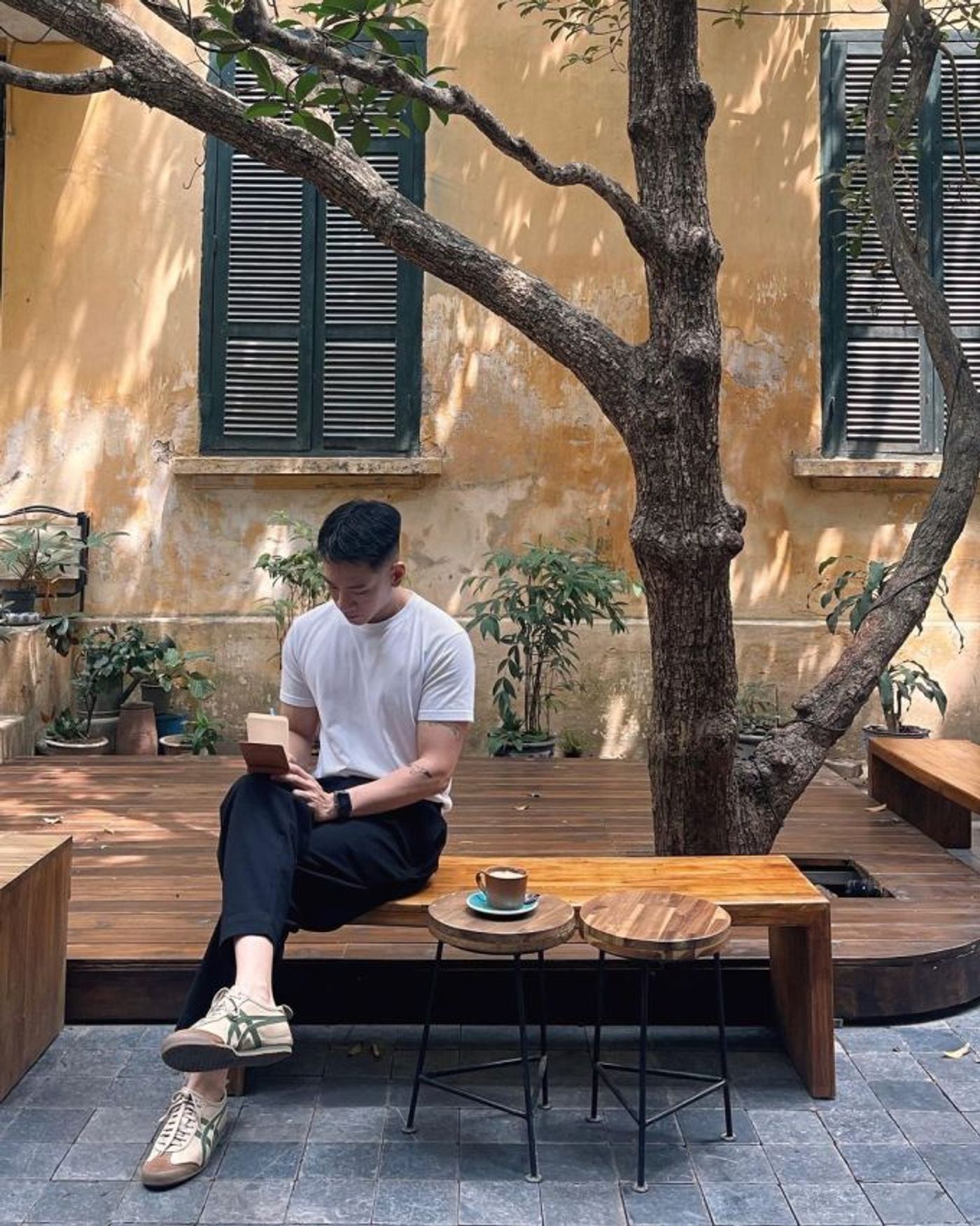 A man drinks coffee at Tranquil Books & Coffee on Cao Ba Quat Street, Hanoi. Photo courtesy of Instagram/miinhmin